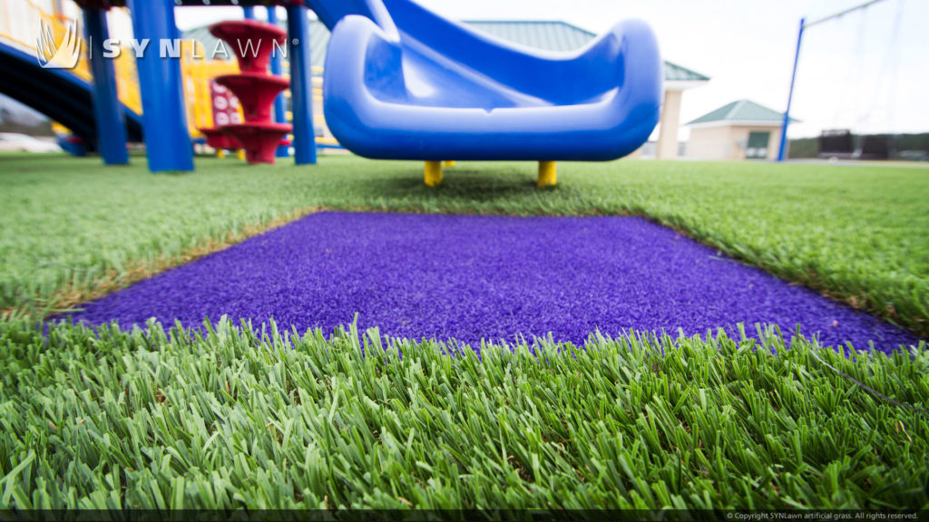 Blue slide on artificial playground grass