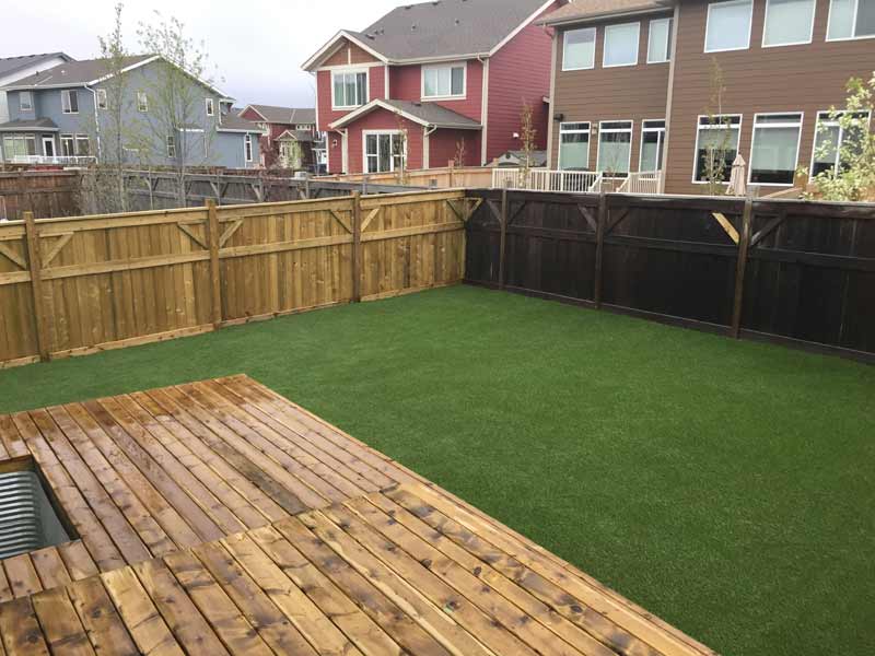 artificial grass backyard and wood fence
