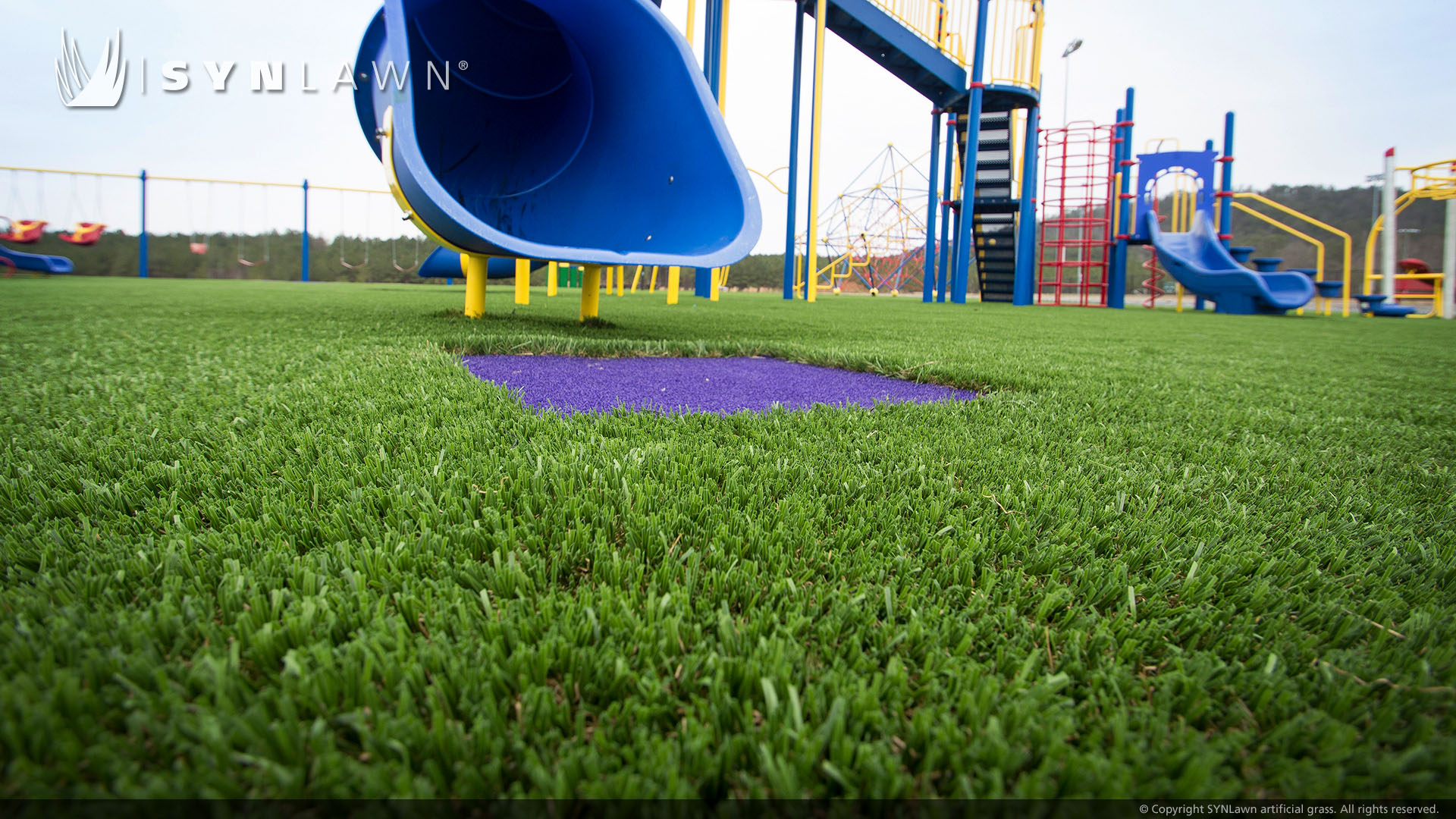 Slide and jungle gym on artificial playground turf
