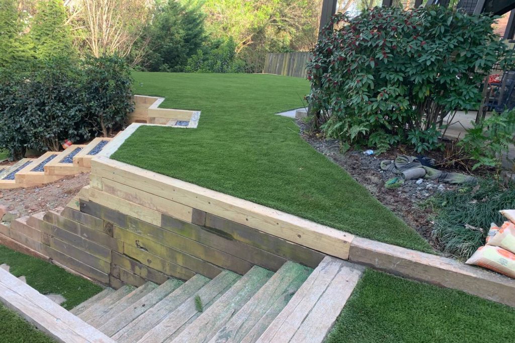 Artificial grass landscape with wooden stairs