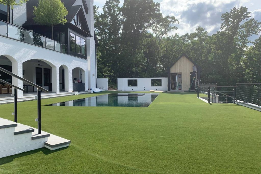 residential artificial grass backyard with pool