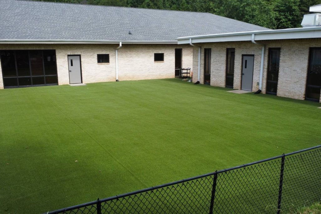 Commercial artificial grass fenced in area